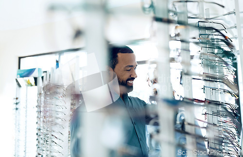 Image of Optometry, glasses and man for eye care decision, choice and options in optician store for vision. Healthcare, ophthalmology and person in clinic to choose prescription lens, spectacles and frames