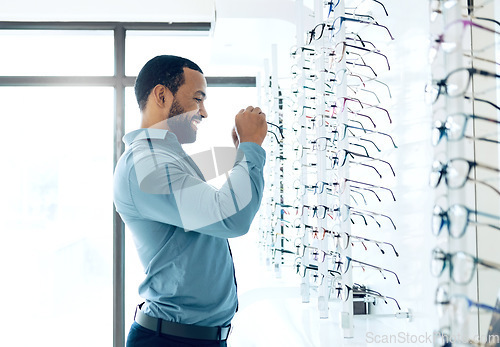 Image of Ophthalmology, glasses and man for eye care decision, choice and options in optician store for vision. Healthcare, optometry and person in clinic to choose prescription lens, spectacles and frames