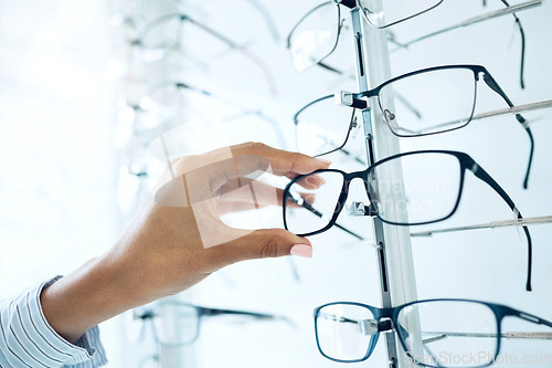 Image of Optometry store, glasses and hands of person for lens frame decision, retail shop choice or eyewear sales. Eye care clinic, vision eyesight support and closeup client, customer and choose eyeglasses