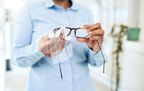 Image of Hands, cleaning glasses with fabric and hygiene, vision and eye care with health and wellness. Person with eyewear, maintenance and wipe away dust with microfiber cloth, closeup and frame with lens