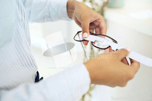 Image of Hands, measure lens and frame of glasses, person in optometry clinic with eye care, test and healthcare. Eyewear, wellness and prescription with health, spectacles and optometrist with ruler tools