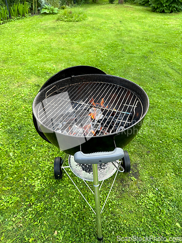 Image of open charcoal grill