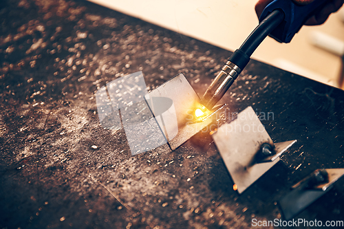 Image of TIG welder is holding welding torch