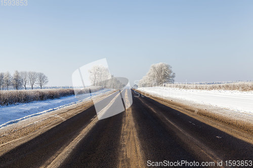 Image of narrow snow-covered winter road