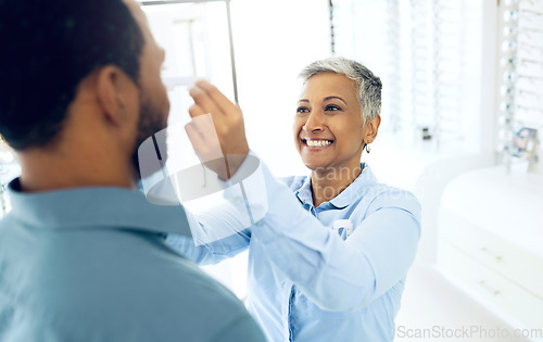 Image of Woman optometrist, fitting and customer in store with consultation for helping health and vision. Happy client, optician and eye care equipment with appointment, prescription glasses and reading