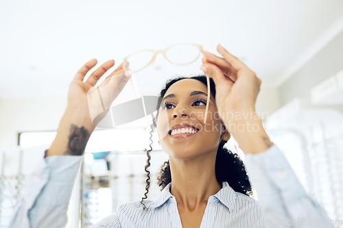 Image of Optometry store, glasses and happy woman check lens frame quality, retail shop choice or eyewear accessory. Eye care product, vision support and shopping client, customer and analysis of eyeglasses
