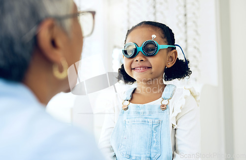 Image of Vision, glasses or eye test with a girl and optician in an eyewear store for prescription frame lenses. Medical, consulting or spectacles with a young child and woman optometrist in an office