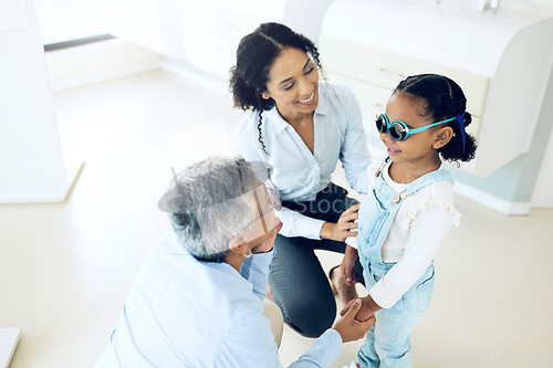 Image of Optometry, glasses and optometrist with child and mother at an eye care appointment for test. Health, wellness and senior optician with young mom and girl kid patient with lenses in an optical clinic