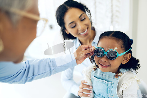 Image of Trial lens, optometry and optometrist with child and mother at eye care appointment for vision test. Health, medical and senior optician with mom and girl kid patient with tool in an optical clinic.