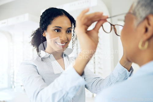 Image of Optometrist, eye care choice or customer with glasses for vision in a retail optical or eyewear shop. Happy woman, smile or client with new spectacles, frame or doctor at optics clinic store for help