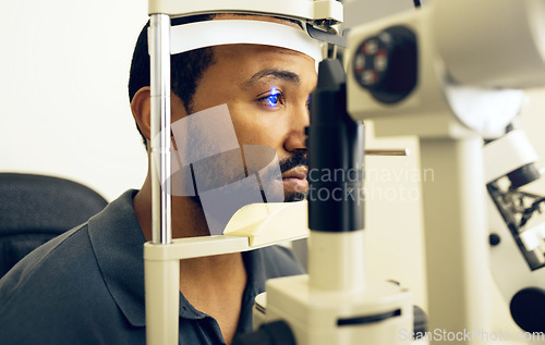 Image of Man, eye exam and ophthalmology for medical, vision and healthcare consultation with glaucoma check. African person or client with laser, blue light and machine for scanning and optometry in office