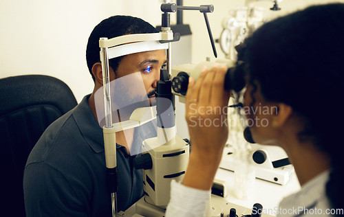 Image of Man, eye exam and optometry for vision, medical and healthcare consultation with glaucoma check. Client and doctor or expert with laser, blue light or machine for scanning eyes and ophthalmology test