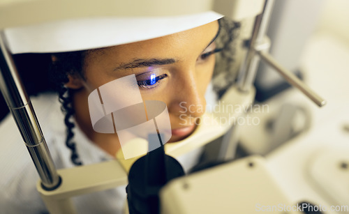 Image of Woman, face and eye exam with vision and laser machine, health and vision with top, optometry and wellness at clinic. Patient, healthcare and scan retina for assessment, prescription and technology