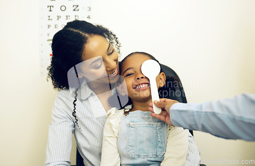 Image of Optometry, vision test and optometrist with child and mother at an eye care appointment for consultation. Health, medical and optician with young mom and girl kid patient with tool in optical clinic.