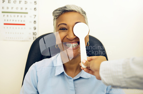 Image of Eye exam, woman or portrait with cover for vision, healthcare or test at optometrist or optometry. Eyes assessment, ophthalmology or person for medical support, glaucoma or retina testing or smile