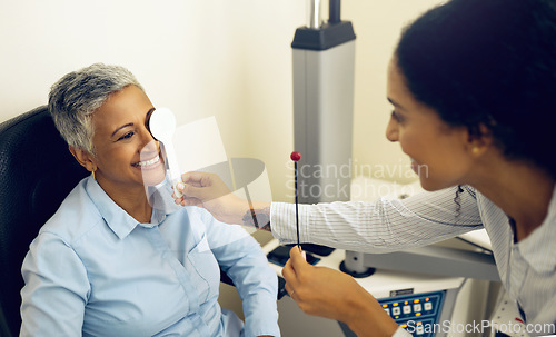 Image of Woman, eye exam and occluder with optometrist in clinic, check and lens for vision, wellness or healthcare. Doctor, eyesight tools and smile for help in assessment, consultation or cover in hospital