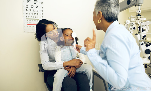 Image of Eye exam, optical and optometrist with child and mother at an eye care appointment for vision test. Health, wellness and senior optician with mom and girl kid patient with lenses in optometry clinic.