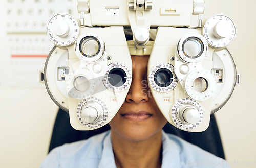 Image of Eye test, face or woman consulting to help eyesight at optometrist for a optical assessment. Optometry, wellness or customer in clinic for vision, iris or retina health with machine or phoropter