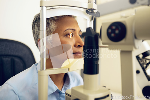 Image of Senior woman, eye exam with vision and laser machine, health and vision with optometry and wellness at clinic. Patient, LED light and scan retina for assessment with prescription and technology