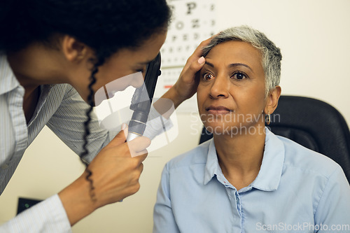 Image of Woman, eye care and healthcare in clinic with ophthalmoscope to check for glaucoma, ocular services or assessment. Optometrist, expert and retina analysis for eyesight exam of patient with lens tools