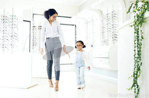 Image of Eyeglasses store, family holding hands and child shopping for prescription lens, visual product or youth eyewear. Vision wellness, ocular eye care and young kid, mother or customer for glasses sale