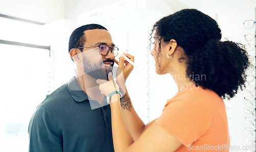 Image of Man, woman optometrist and glasses fitting in store with prescription, eye care and healthy vision. Male customer, consulting and optician with spectacles for better eyesight, reading and wellness