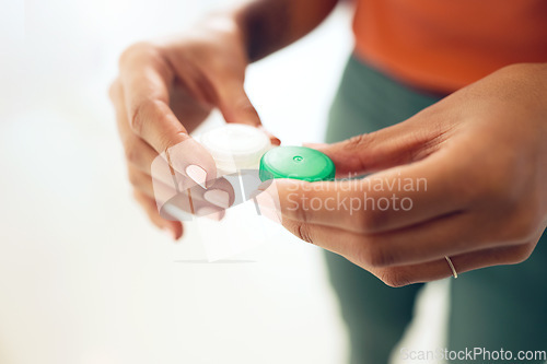 Image of Hands, contact lens and container with vision and eye care, health and closeup with medical care or cosmetic. Optometry, wellness and healthcare with person and plastic case, visual and improvement