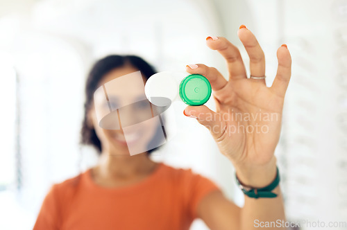 Image of Hand, vision and contact lens container with a person at the optometrist for eye care or health closeup. Healthcare, medical and plastic case with a customer at the optician for a checkup appointment