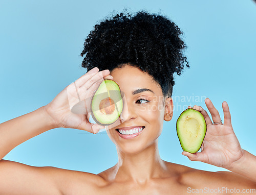 Image of Avocado, skincare and beauty, woman with natural benefits and product for face on blue background. Health, wellness and facial mask, smile with green fruit and vegan for dermatology in studio