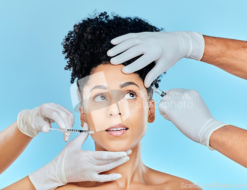 Image of Skincare, needle and filler, woman with hands on face in studio at plastic surgery consultation. Model with facial, aesthetic and salon for beauty, dermatology or collagen therapy on blue background