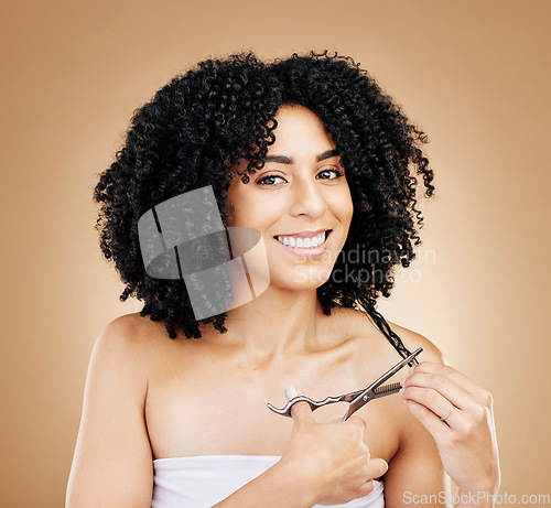 Image of Hair, scissors with curls and portrait of woman, beauty and cosmetic care and change on studio brown background. Wellness, haircare and haircut with strong texture and cut locks, volume and afro