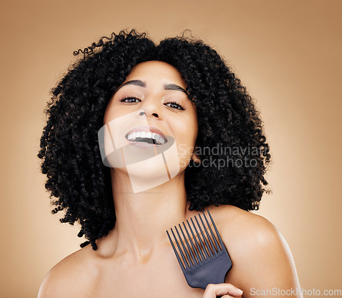 Image of Portrait, hair care and woman with a comb, afro and salon treatment with volume on brown background. Face, person or model with grooming, shine or glow with beauty, texture or aesthetic with keratin