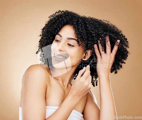 Image of Afro, hair and comb of woman in studio with healthy coil texture, natural growth or cosmetics on brown background. Happy model, curly haircare tools or brush for salon aesthetic, care or clean beauty