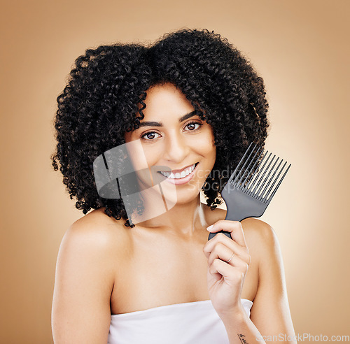 Image of Portrait, hair care and woman with a comb, curls and salon grooming with keratin on brown background. Face, person or model with beauty, shine or glow with volume, cosmetics or smile with aesthetic