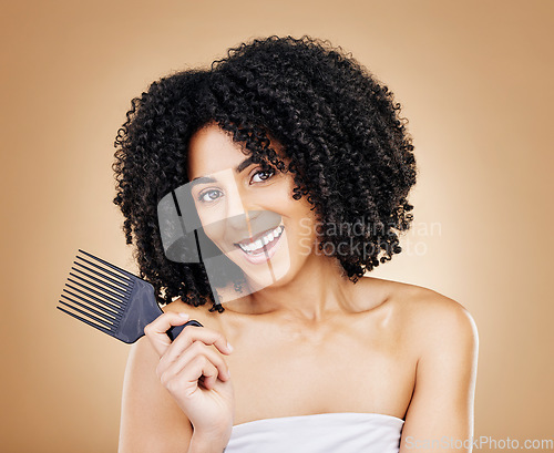 Image of Hair, curls and woman with comb, beauty and treatment for shine, cosmetic care and portrait on studio background. Wellness, haircare and growth with strong texture and brush locks, volume and afro