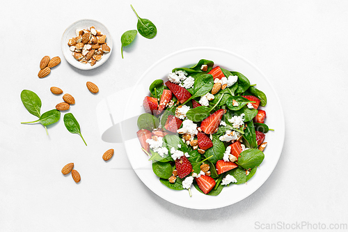 Image of Strawberry and spinach fresh salad with cottage cheese and almonds, top view