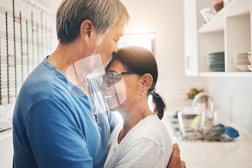 Image of Hug, smile and mature couple kiss in home for care, support or trust together. Embrace, happy man and woman in kitchen for connection, romance or healthy relationship for love, commitment or marriage