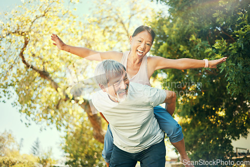 Image of Couple, smile and piggyback in nature for fun, excited and playful in freedom, energy and joy. Happy elderly asian people, airplane and flying in summer, laugh and support for crazy in retirement