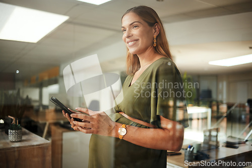 Image of Woman, thinking and phone with smile in office for business, networking or ideas for marketing or pregnant. Person, smartphone and happiness at work for communication, conversation or internet chat