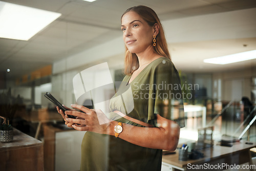 Image of Woman, thinking and smartphone with smile in office for business, networking or ideas for marketing or pregnant. Person, phone and happiness at work for communication, conversation or internet chat
