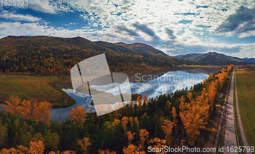 Image of Aerial view of road in beautiful autumn Altai forest