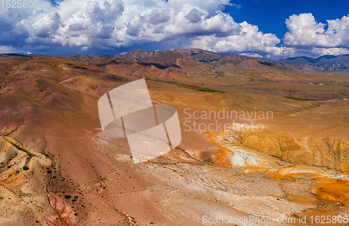 Image of Aerial shot of the textured yellow nad red mountains resembling the surface of Mars