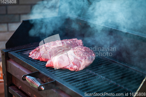 Image of Pork meat steaks on the grill