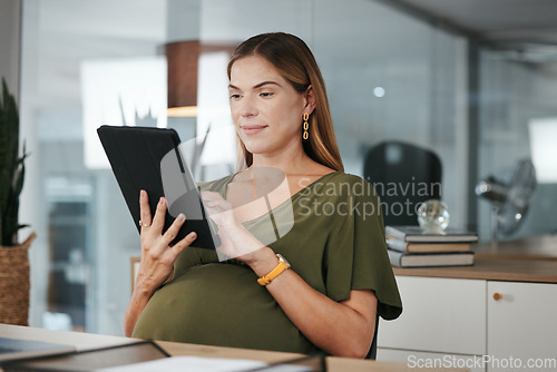 Image of Tablet, networking or pregnant business woman in office on social media, website or internet at desk. Maternity, communication or female designer with pregnancy or technology to scroll in workplace