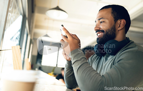 Image of Cafe, man and phone with smile for relax, social media and internet scroll with headphones or meme. Person, smartphone and happiness in coffee shop for technology, funny website or search engine