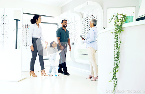 Image of Optometrist, parents and girl child with optician for eye care, eyes assessment or prescription glasses. Family, man or women in store with happiness for visit, appointment or vision test for eyewear