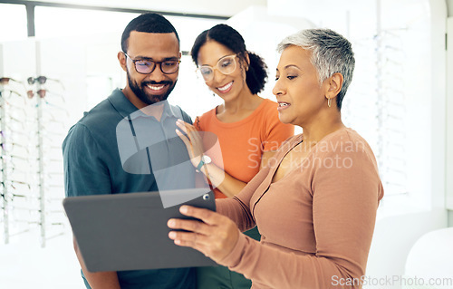 Image of Tablet, optometry and woman with patients in a store for spectacle frame browsing on the internet. Consultation, digital technology and optometrist with people for choosing glasses in optical clinic.