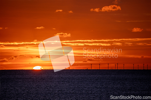 Image of Sun setting over English Channel with Rampion Wind Turbines