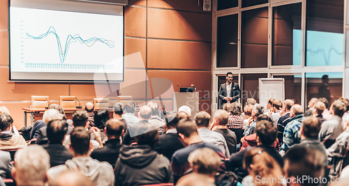 Image of Business speaker giving a talk in conference hall.