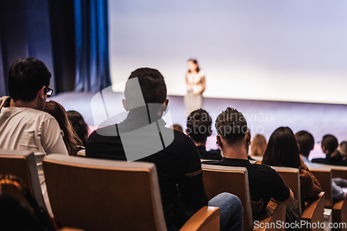 Image of Woman giving presentation on business conference event.